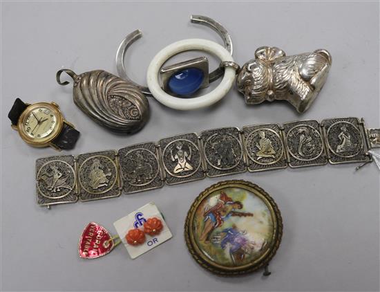A white metal filligree bracelet, two white metal childs rattles, a pair of coral mounted ear studs, a bangle and a limoges brooch.